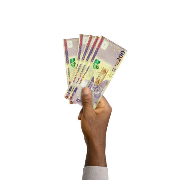 istock Black Hand holding 3D rendered 200 Namibian dollar notes isolated on white background 1408535168