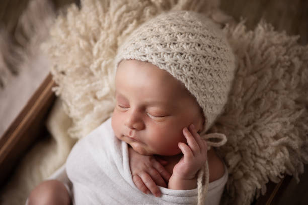 istock Newborn baby boy sleeping in a box 1408543470