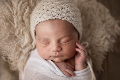 Cute 14 days-old baby boy sleeping confortable inside a box - Natural textures and colors - Buenos Aires - Argentina