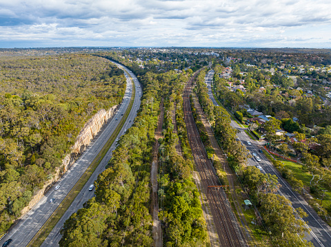 Aerial view of the M1 Pacific Motorway, the Pacific Highway and the train line, looking south bound at Mount Colah, Sydney, Australia