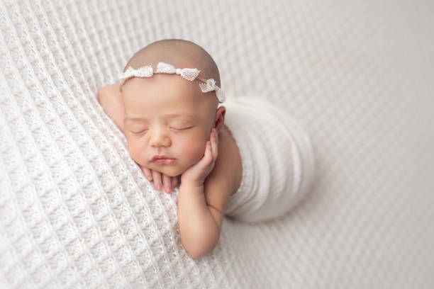 istock Newborn baby girl sleeping 1408543524