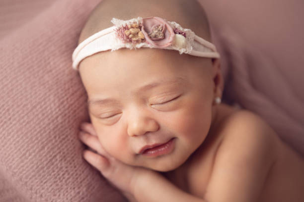 Newborn baby girl sleeping stock photo