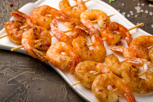 istock tiger shrimp kebabs on white plate, canapes 1408545785