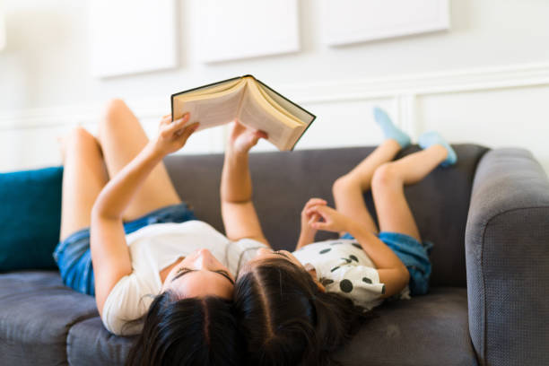 istock Relaxed mom and kid reading a book during a leisure day at home 1408548344
