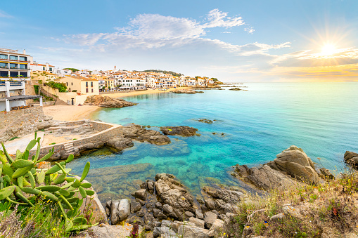 The rocky coast, sandy beach and whitewashed village at the fishing town of Calella de Palafrugell, Spain, on the Costa Brava Spanish coast.