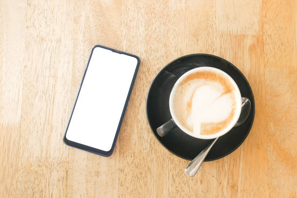 istock a cpu of late coffee with a heart shape design and smart phone on table 1408551294