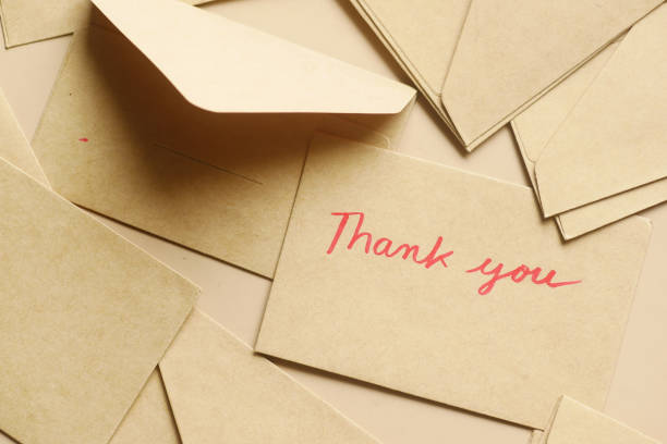 istock thank you message and envelope on wooden table 1408551473