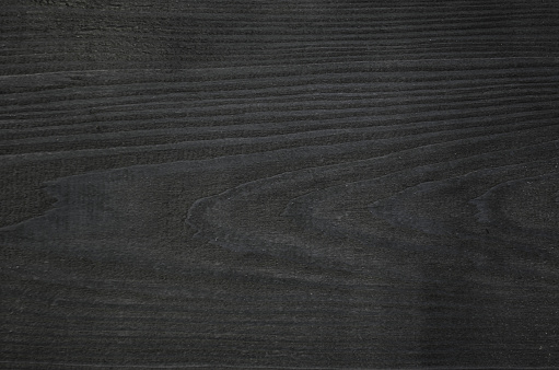 Black wooden surface close up