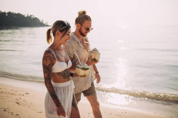 istock Couple walking on the beach 1408556754