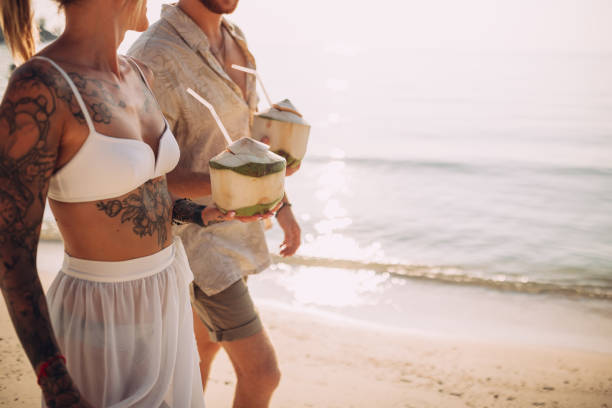 istock Couple walking on the beach 1408556755