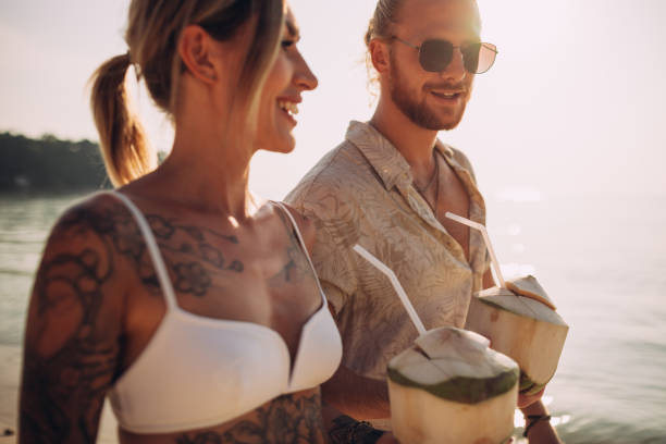 istock Couple walking on the beach 1408556758