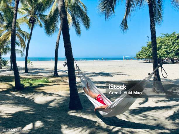 Young Woman Relaxing In Hammock On The Beach Of Santa Marta Colombia Stock Photo - Download Image Now