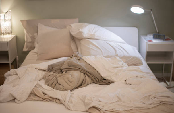 istock Picture of a bed with cluttered blankets 1408560069