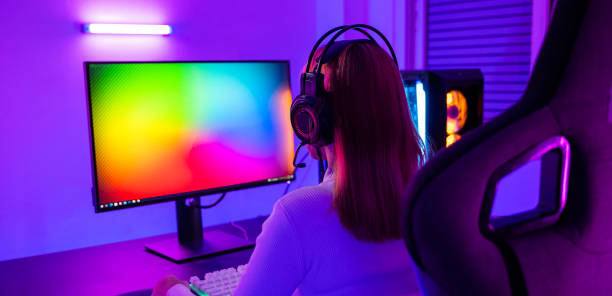 istock Asian professional gamer playing online video game on desktop computer PC have colorful neon LED lights 1408562131