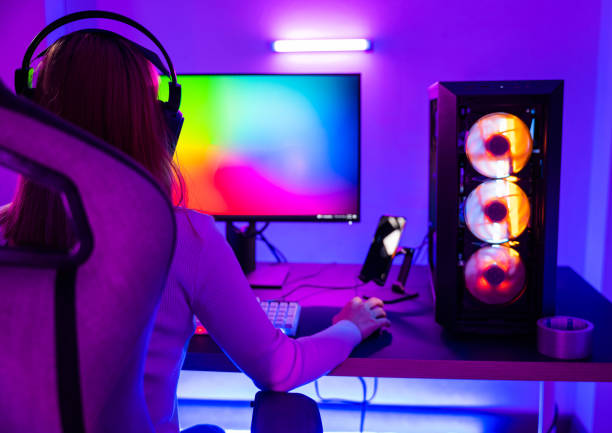 istock Asian professional gamer playing online video game on desktop computer PC have colorful neon LED lights 1408562132
