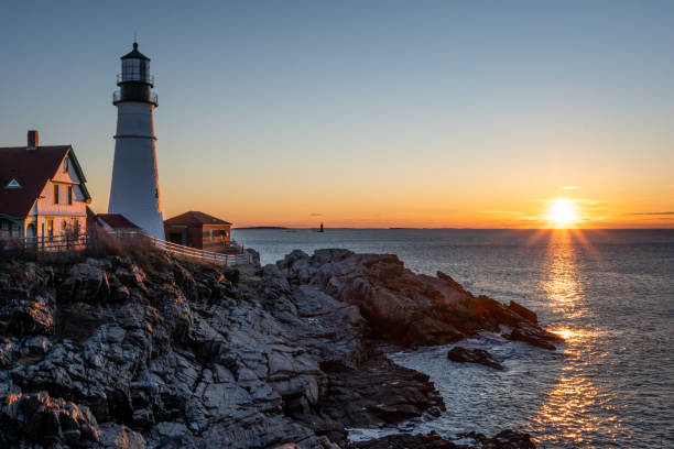 istock Sun rise over cliffs and lighthouse 1408562349