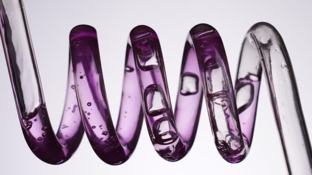 Purple liquid flowing in a spiral tube
