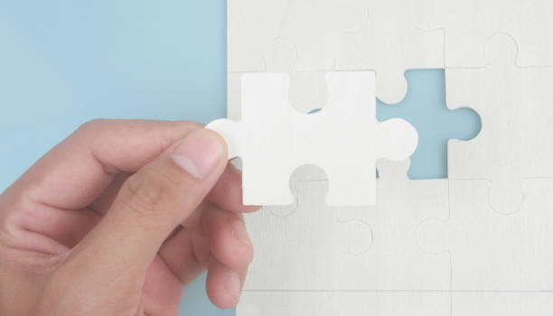istock Connecting jigsaw puzzle in hand. Business solutions success and strategy concept 1408566071