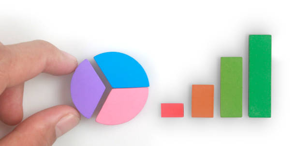 istock Business connecting piece of multi colored pie chart in  hand 1408566075