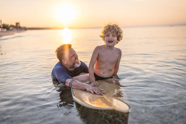 istock Father and son enjoy surfboarding 1408567265