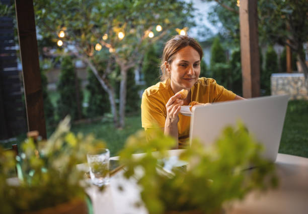 istock Woman with laptop working in garden 1408567623