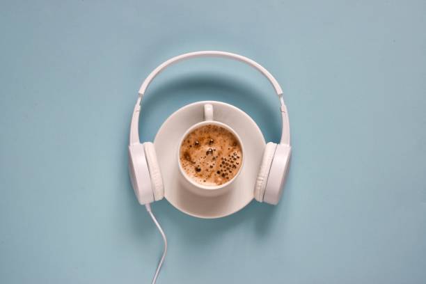 istock Headphones and coffee cup on a light blue background 1408567663