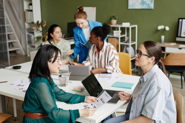 istock Business colleagues discussing report at meeting 1408567887