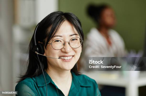 Asiatische Bedienerin In Kopfhörern Stockfoto und mehr Bilder von Immobilienmakler - Immobilienmakler, Am Telefon, Headset