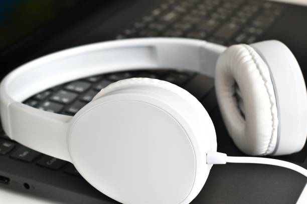 istock Headphones on laptop computer keyboard concept for communication, it support, call center and customer service help desk. 1408568434