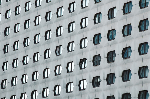 the facade of the building with many windows in the form of honeycombs. Hotel Azimut. three-star hotel in Siberia. Novosibirsk, Russia - October, 15, 2021