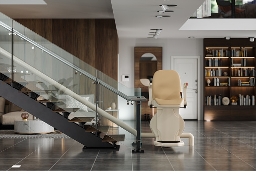 Automatic Stair Lift On Staircase In Modern House With Blurred Background