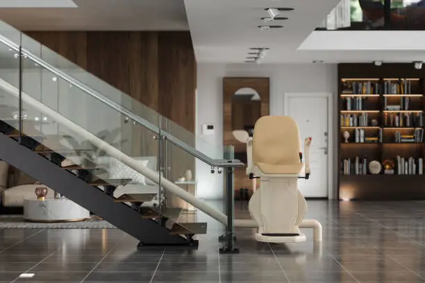 Photo of Automatic Stair Lift On Staircase In Modern House With Blurred Background