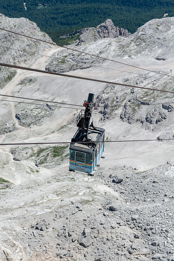 Cortina d'Ampezzo, Dolomites, Italy - July, 8,  2022 : Cable car or Gondola lift ascending from Cortina d'Ampezzo to Tofana di Mezzo in the summer.