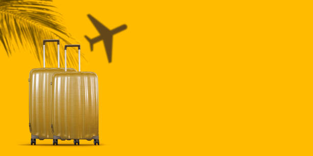 istock Tropical travel concept with suitcases on yellow background. 1408572693