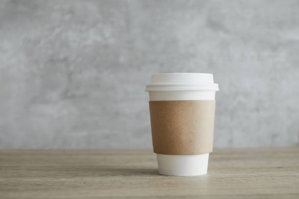 istock Coffee paper cup on wooden table. Take away hot drink. 1408574867