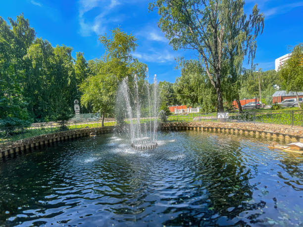 istock Fountain in the park against the blue sky 1408578103