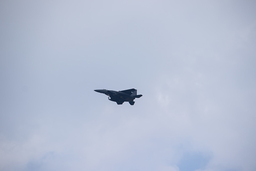 DAEGU, REPUBLIC OF KOREA - JUNE 15, 2022 :  A fighter jet flying in a cloudy sky.