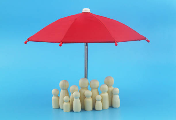 istock Family people figures under red umbrella on blue background. 1408580056