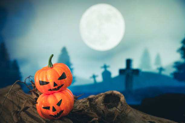 istock Spooky cemetery with glow halloween pumpkin 1408580413