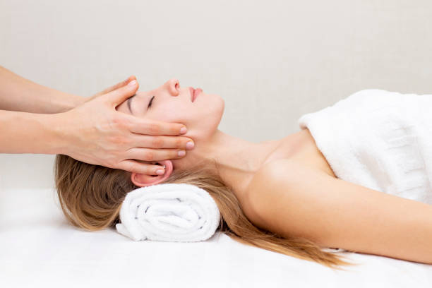 istock Young woman enjoying massage in spa salon. 1408580514