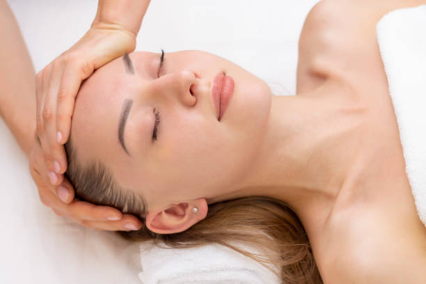 istock Young woman enjoying massage in spa salon. 1408580577