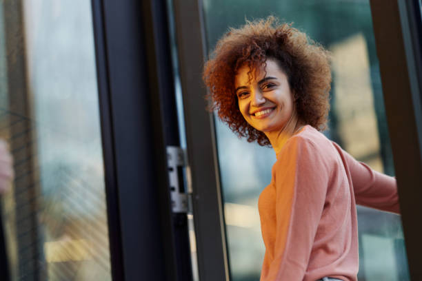 istock Happy woman entering the building. 1408582660