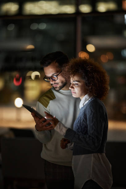 istock Millennial couple using touchpad in the dark. 1408583959