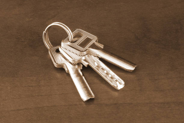 Bunch of silver  keys on wooden table