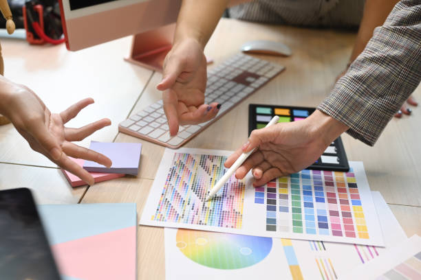istock Cropped view of young creative people brainstorming, discussing ideas for design project together. 1408589181