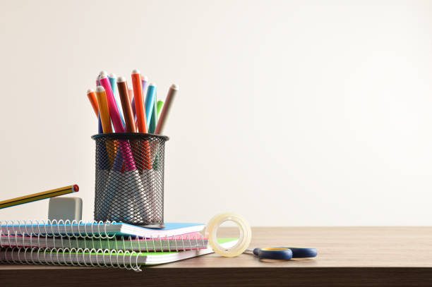 istock School supplies with penholder on notebooks on desk front view 1408589590