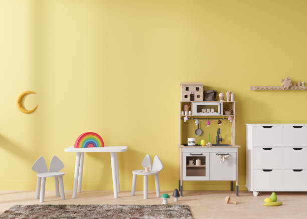 istock Empty yellow wall in modern child room. Mock up interior in scandinavian style. Copy space for your picture or poster. Table with chairs, sideboard, toys. Cozy room for kids. 3D rendering. 1408591211