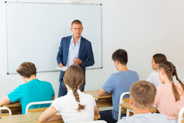istock Teenager students sitting at desks 1408593953
