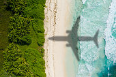 istock Airplaine arriving on tropical holiday destination. Vacation concept 1408594392