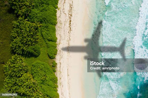 Airplaine Arriving On Tropical Holiday Destination Vacation Concept Stock Photo - Download Image Now
